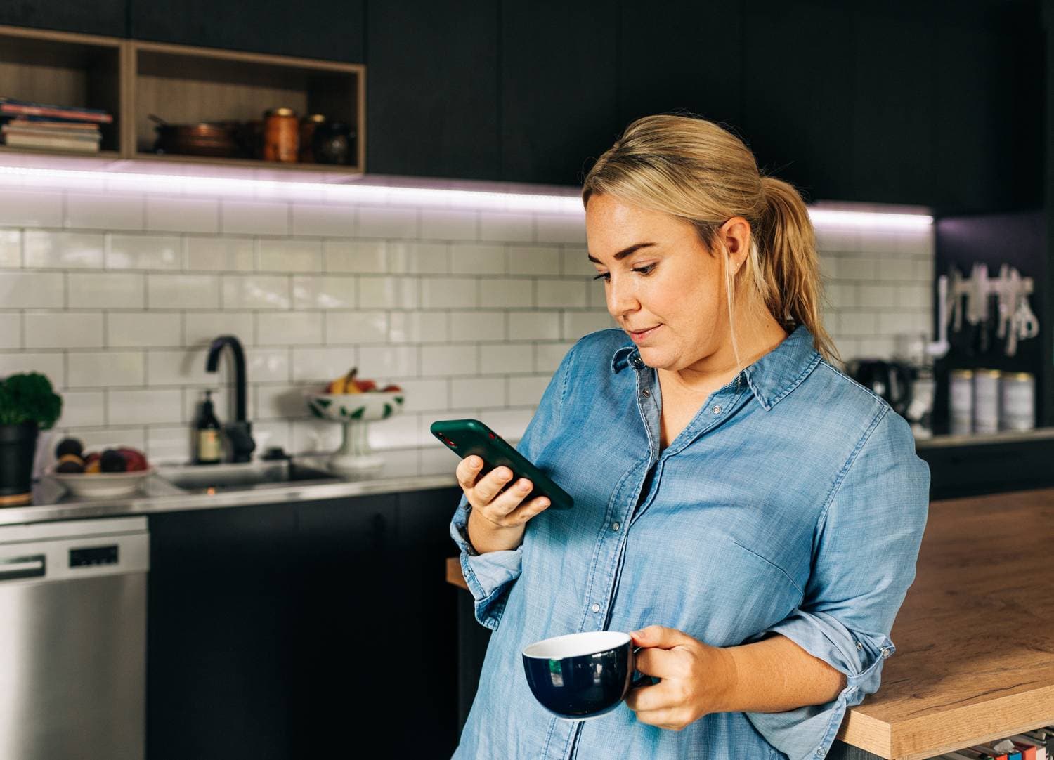 Woman using smartphone to find professionals professionals near your area on NearbyHunt